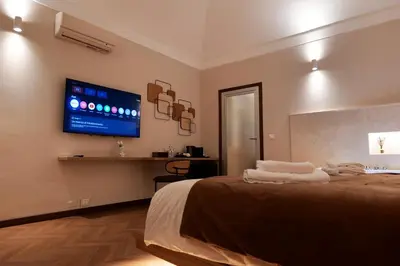 a bedroom with a bed with a tv on the wall at HeySuite Classic - Luxury House - Navona in Rome