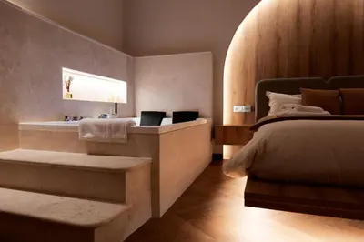 a bedroom with a bed and a bathroom with a sink at HeySuite Classic - Luxury House - Navona in Rome