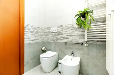 a bathroom with a toilet and a sink at La casetta di Trastevere in Rome