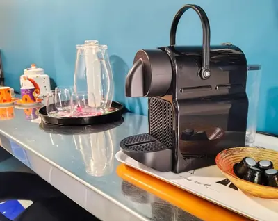 a table with a coffee maker on a counter at La casetta di Trastevere in Rome