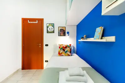 a blue room with a bed with a blue wall at La casetta di Trastevere in Rome