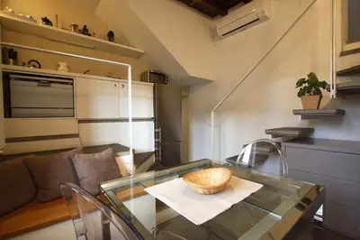 a glass table with a bowl on it in a room at Il Nido sui Tetti di Piazza Navona in Rome