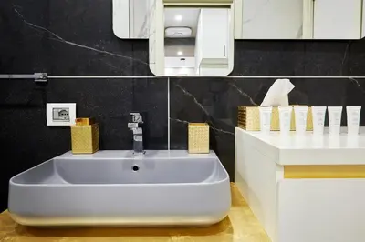 a bathroom with a white sink and a mirror at Roma Vaticano Deluxe Apartment in Rome