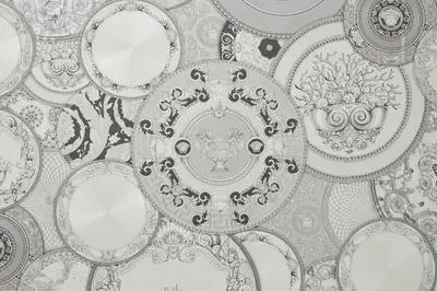 a black and white photo of plates on a wall at Roma Vaticano Deluxe Apartment in Rome