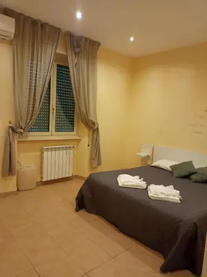 a bedroom with a bed with two towels on it at Gemelli House in Rome
