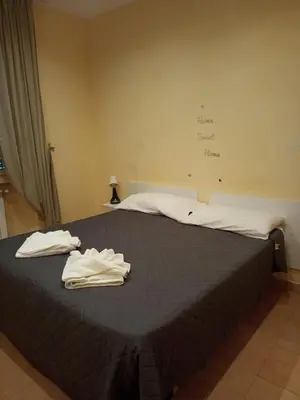 a bedroom with a bed with two towels on it at Gemelli House in Rome
