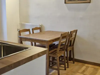 a wooden table and chairs in a kitchen at Be Your Home - CasAngelica in Rome