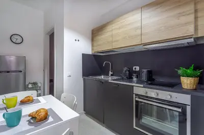 a kitchen with a table with bread on it at iFlat Colosseo Prestige in Rome
