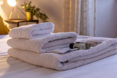 a pile of towels sitting on top of a bed at iFlat Colosseo Prestige in Rome