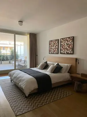 a bedroom with a large bed with a rug at La Dolce Vita - Trastevere Luxury Stylish Studio in Rome