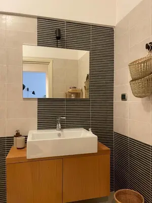 a bathroom with a white sink and a mirror at La Dolce Vita - Trastevere Luxury Stylish Studio in Rome