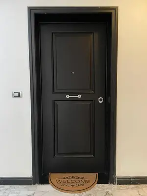 a black door with a sign in front of it at La Dolce Vita - Trastevere Luxury Stylish Studio in Rome