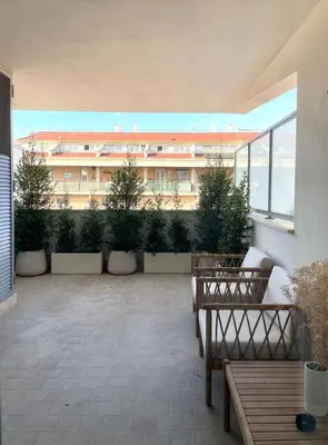 a patio with benches and a building in the background at La Dolce Vita - Trastevere Luxury Stylish Studio in Rome