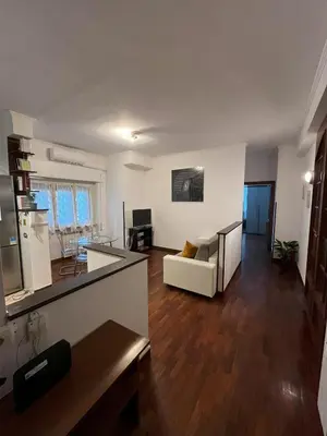 a living room with a couch and a table at Moonlight Vatican by ACS HOLIDAYS in Rome