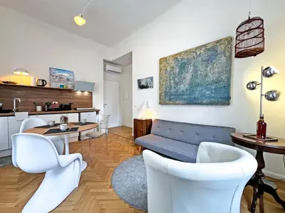 a living room with a couch and a table and chairs at Roma Parioli - Suite Mediterranea in Rome