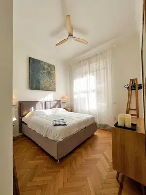 a bedroom with a bed and a ceiling fan at Roma Parioli - Suite Mediterranea in Rome