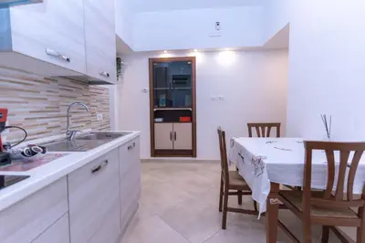 a kitchen with a sink and a table with chairs at Casa Arco in Rome