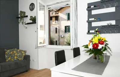 a living room with a table with a vase of flowers at Casetta Garbatella in Rome
