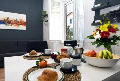 a table with plates of food and a bowl of fruit at Casetta Garbatella in Rome