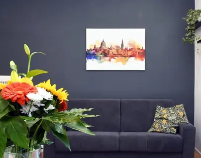 a living room with a couch and a painting at Casetta Garbatella in Rome