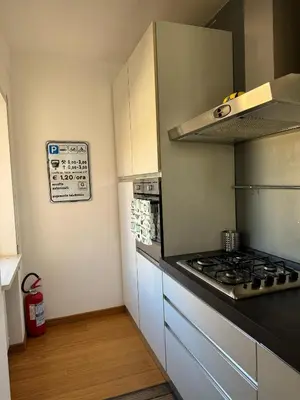 a kitchen with a stove and a counter top at Splendido Attico con Terrazza a Trastevere in Rome