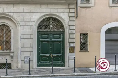 a green door on the side of a building at C M Barberini Vacation in Rome