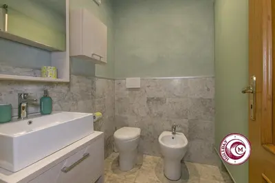 a bathroom with a sink and a toilet at C M Barberini Vacation in Rome