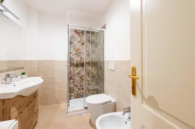 a bathroom with a toilet sink and a shower at Loft nel Cuore della Capitale in Rome