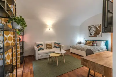 a living room with a couch and a table at Fresh House Sapienza in Rome