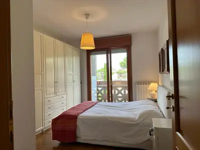 a white bedroom with a bed and a window at The Vatican Studio in Rome