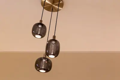 a group of three lights hanging from a ceiling at iFlat Vatican New Bright & Comfy 3 Bedroom apt in Rome