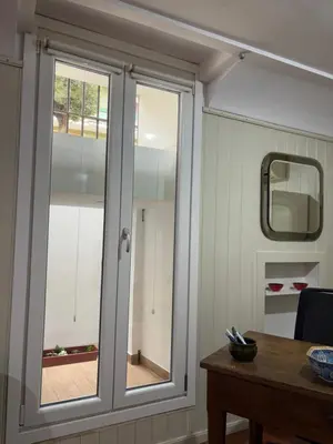 a sliding glass window in a room with a table at Appia apartment in Rome