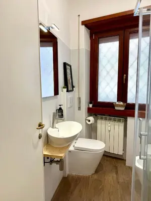 a white bathroom with a toilet and a sink at SarHome in Rome