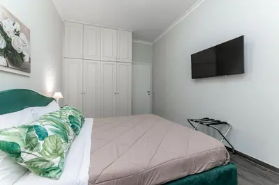 a bedroom with a bed and a flat screen tv at Francesca Suite - Metro Basilica San Paolo in Rome