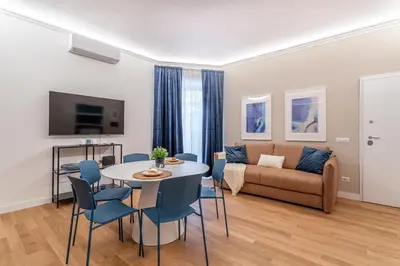 a living room with a couch and a table and chairs at iFlat Rome Dream, New Cozy & Chic Apartment in Rome