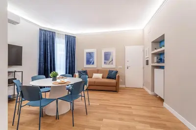a living room with a table and chairs and a couch at iFlat Rome Dream, New Cozy & Chic Apartment in Rome