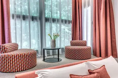 two chairs and a table in front of a window at Parioli Cube Hotel in Rome