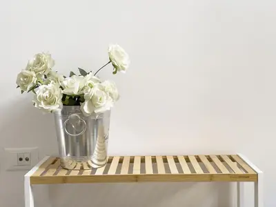 a vase of white flowers sitting on a table at Eclectic Apartment in Trendy San Lorenzo in Rome