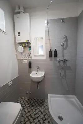 a bathroom with a shower and a sink and a toilet at Eclectic Apartment in Trendy San Lorenzo in Rome