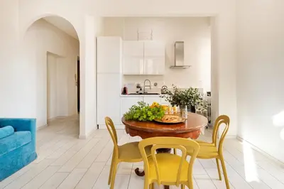 a kitchen and dining room with a table and chairs at Green apartment Rome in Rome