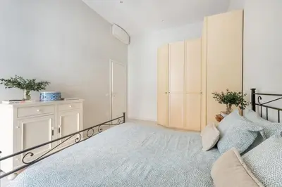 a bedroom with a bed and a dresser at Green apartment Rome in Rome