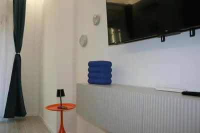 a room with a shelf with blue bowls on it at Terrazza Majorana in Rome