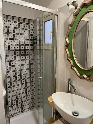 a bathroom with a sink and a mirror at Suite Crescenzio in Laterano in Rome