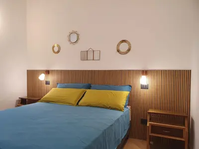 a bedroom with a bed and two clocks on the wall at Quiet and cosy central apartment in Rome