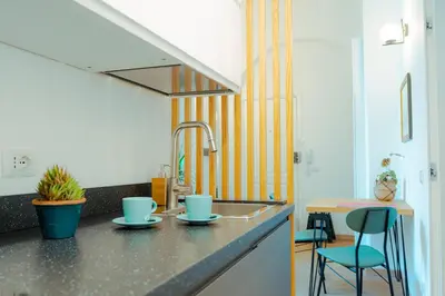 a kitchen with a sink and blue cups on a counter at Quiet and cosy central apartment in Rome