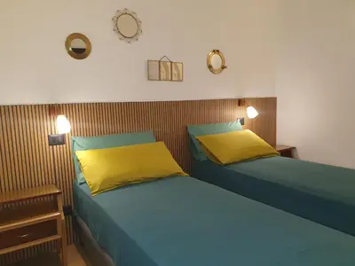 two beds sitting next to each other in a bedroom at Quiet and cosy central apartment in Rome