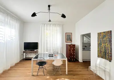 a dining room with a glass table and chairs at Roma Parioli - Loft Style in Rome