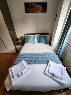 a bedroom with a bed with towels on it at Al Gondar 7 Libia Roma in Rome