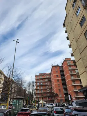 a parking lot with cars parked in front of buildings at Al Gondar 7 Libia Roma in Rome