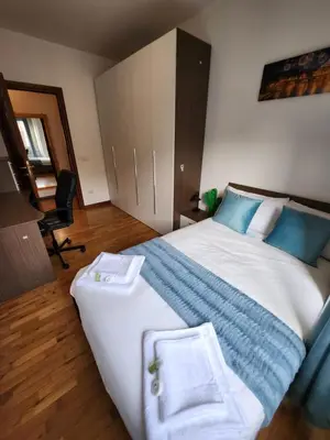a bedroom with a large bed with two towels on it at Al Gondar 7 Libia Roma in Rome